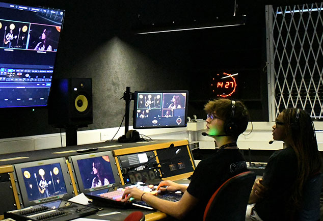 Students in media room with screens and camera angles