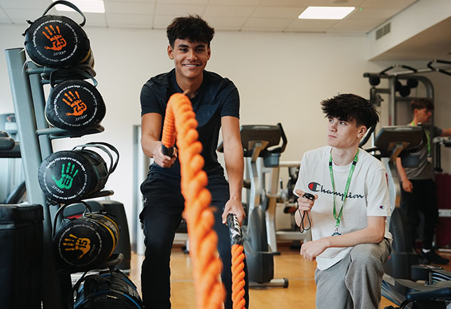 Student in gym using equipment 