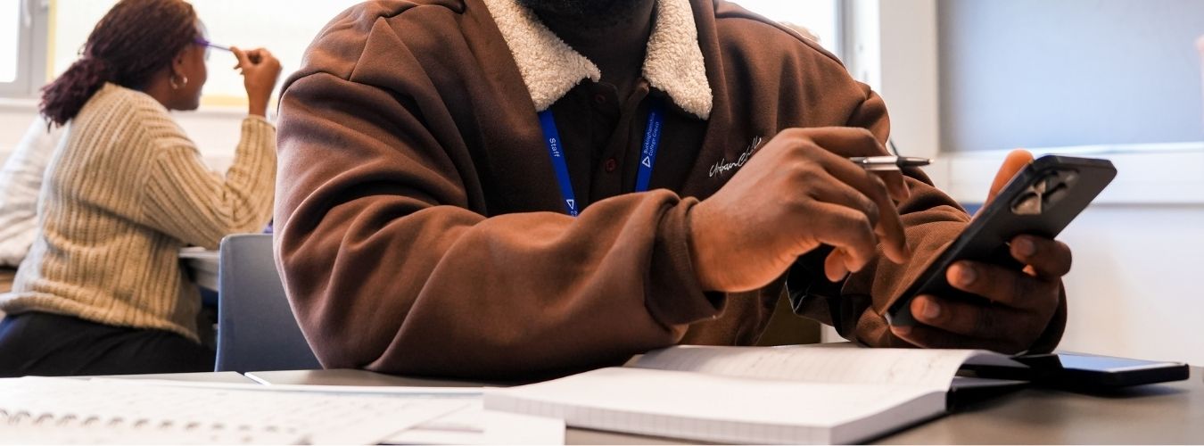 Person sitting at desk using calculator