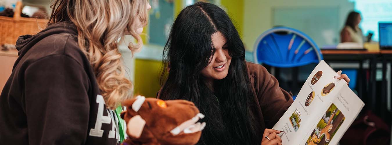Students looking at children's book