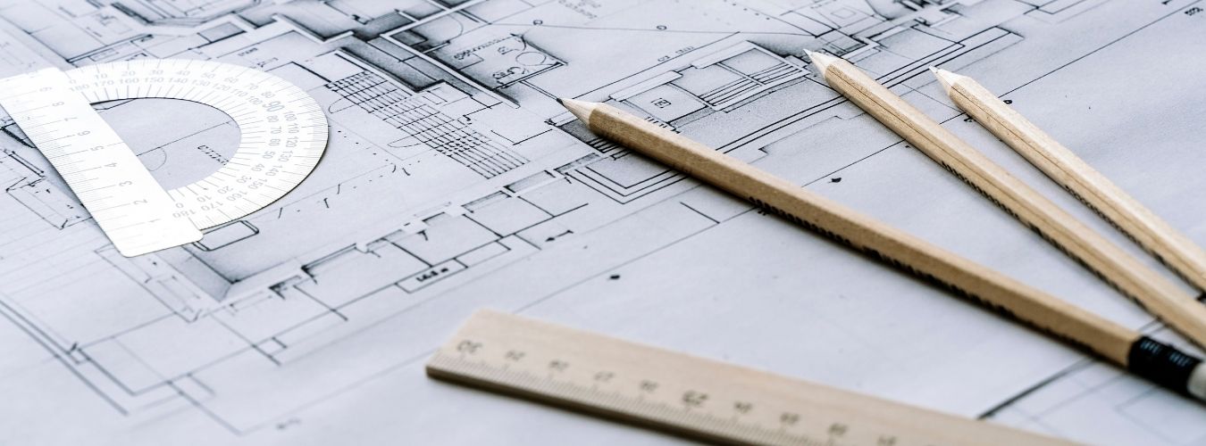 Building plans on paper with pencil and ruler on top