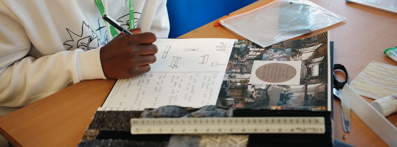 Student drawing in sketchbook