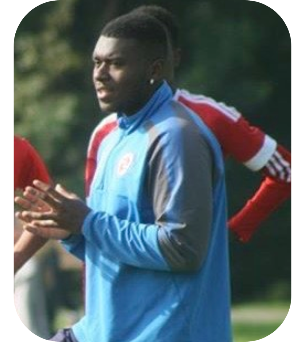 Photo of former student in his current role as a Football Coach.