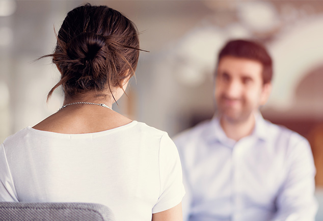 Blurred image of man sitting across a female