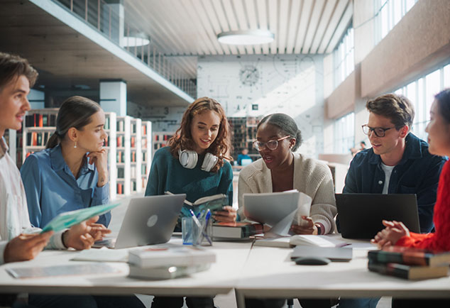 Group of students sitting around a table talking 