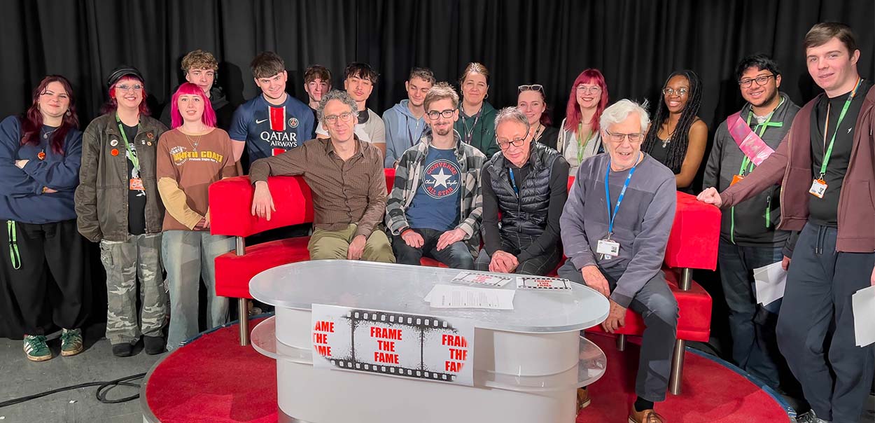 Robert Wilfort sitting in TV studio at the Amersham campus surrounded by students
