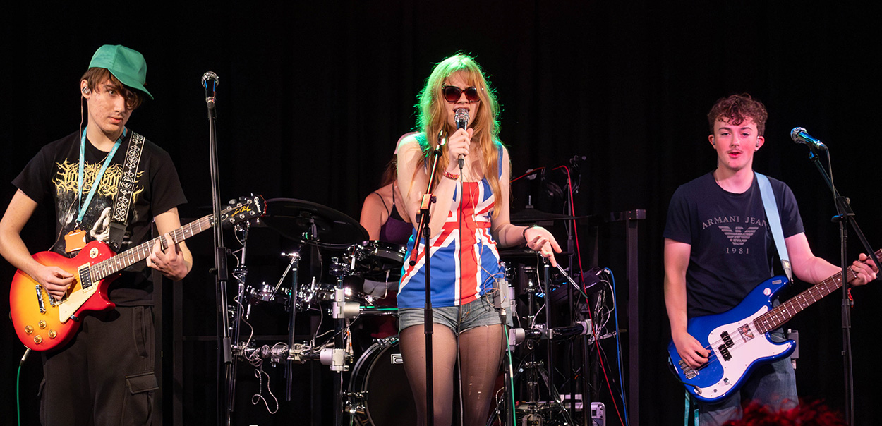 Music students on stage performing at the Halloween gig