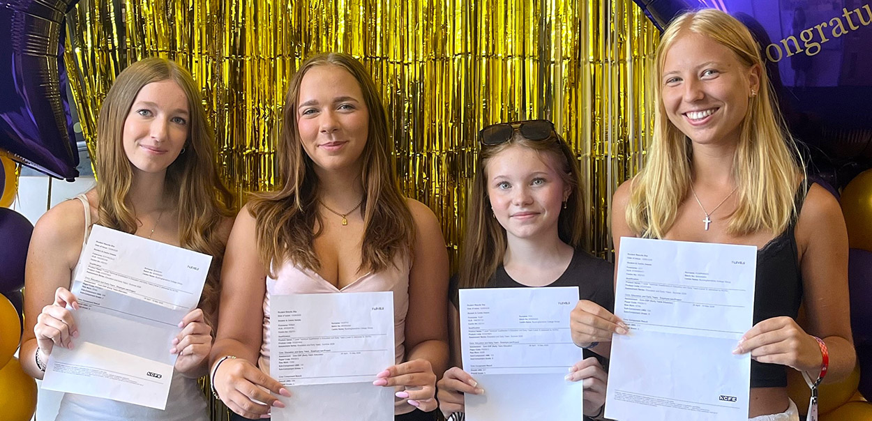 Four female students show their Level 3 Results