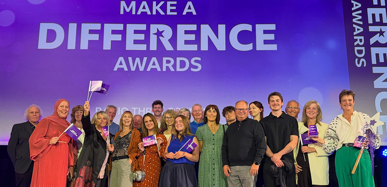 Mission EmployAble Team Celebrate BBC Make a Difference Community Group Award on stage at the Grove Theatre Dunstable